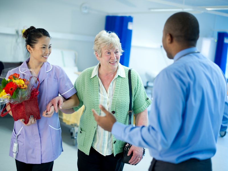 Caregiver accompanying senior after hospital visit