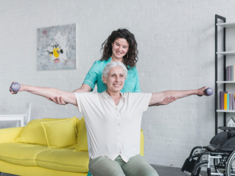 Caregiver Helping Senior with Simple Exercise at Home