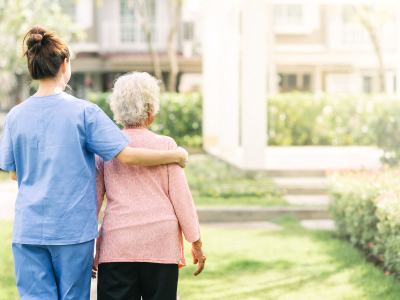 Senior and Caregiver on a Walk