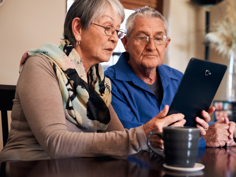 elderly people looking at a tablet