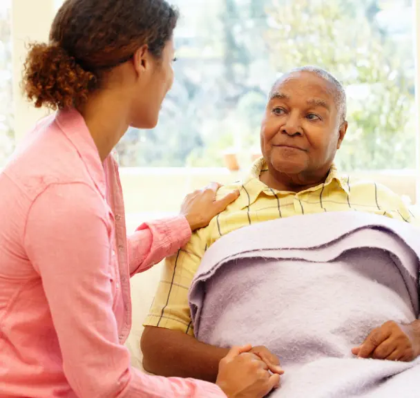 A young woman takes care of an old man