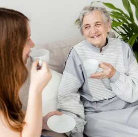 A young woman takes care of an old woman