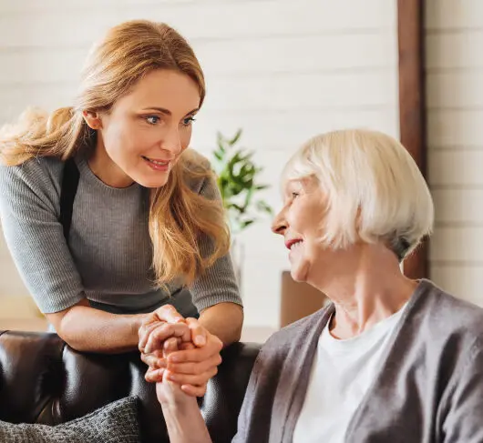 A young woman takes care of an old woman
