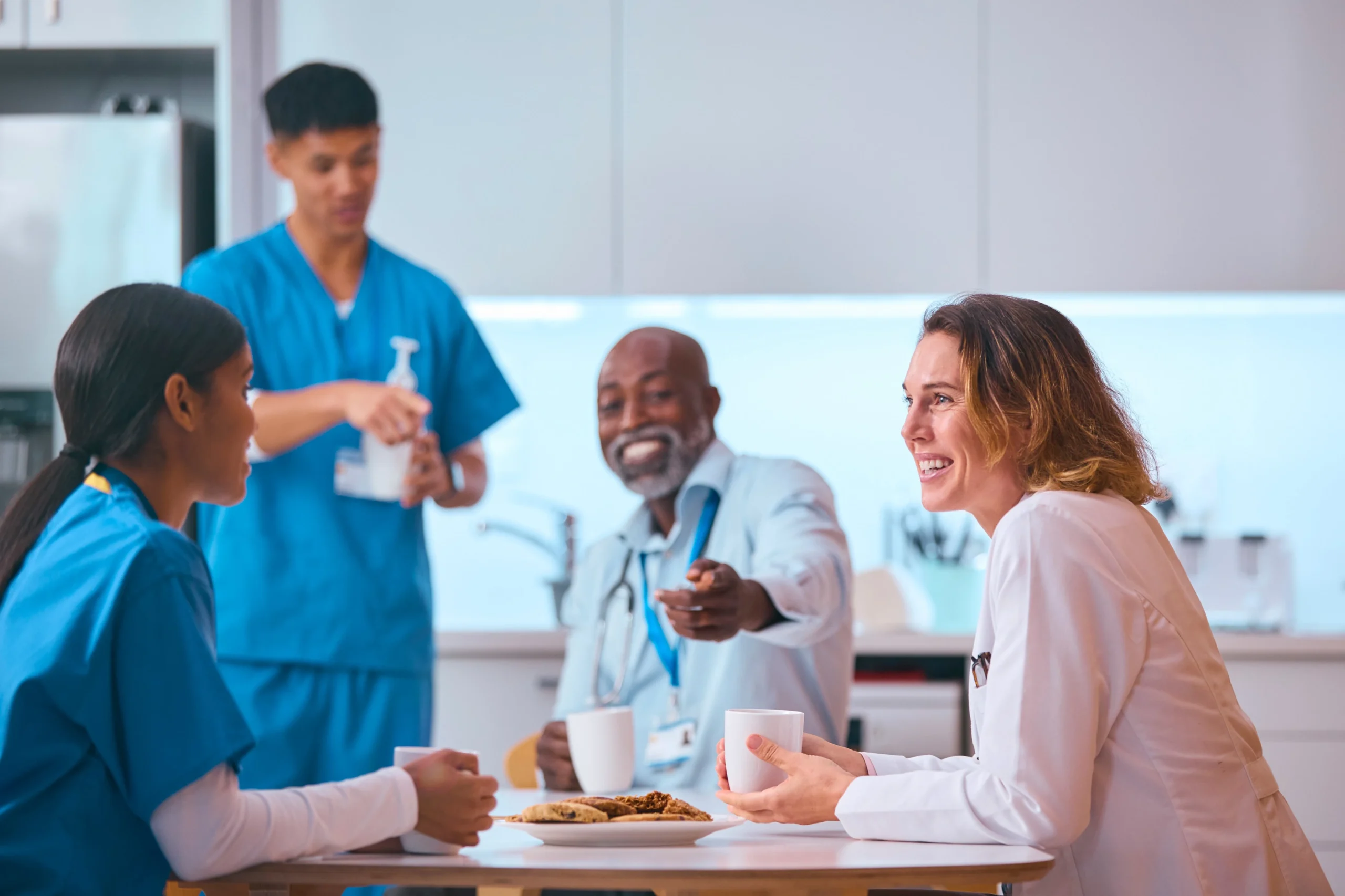 Diverse group of home care professionals enjoying a coffee break together.