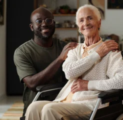 Caregiver providing emotional support to an elderly woman at home, enhancing comfort and well-being through personalized home care.